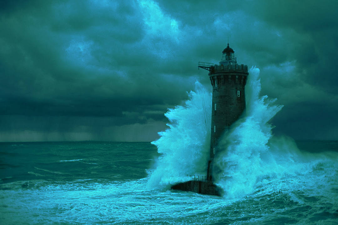 Lighthouse standing in heavy surf